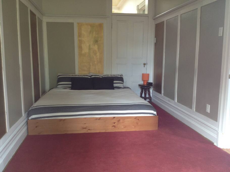 Main bedroom (with king bed), with balcony facing street.