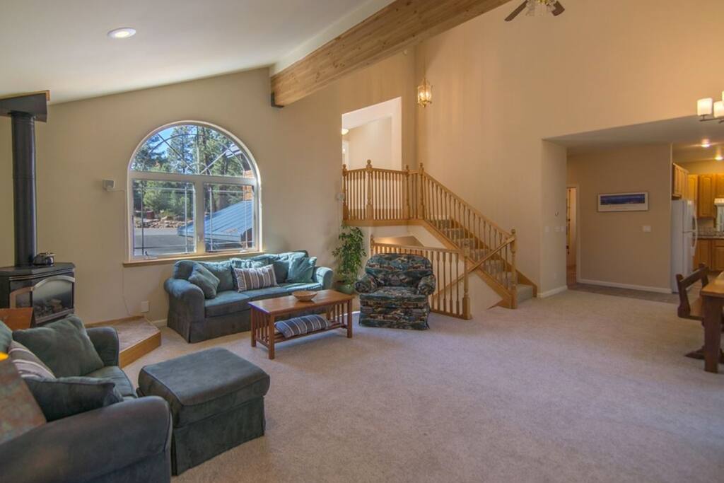 Large, open living room with high ceilings and lots of light on main level