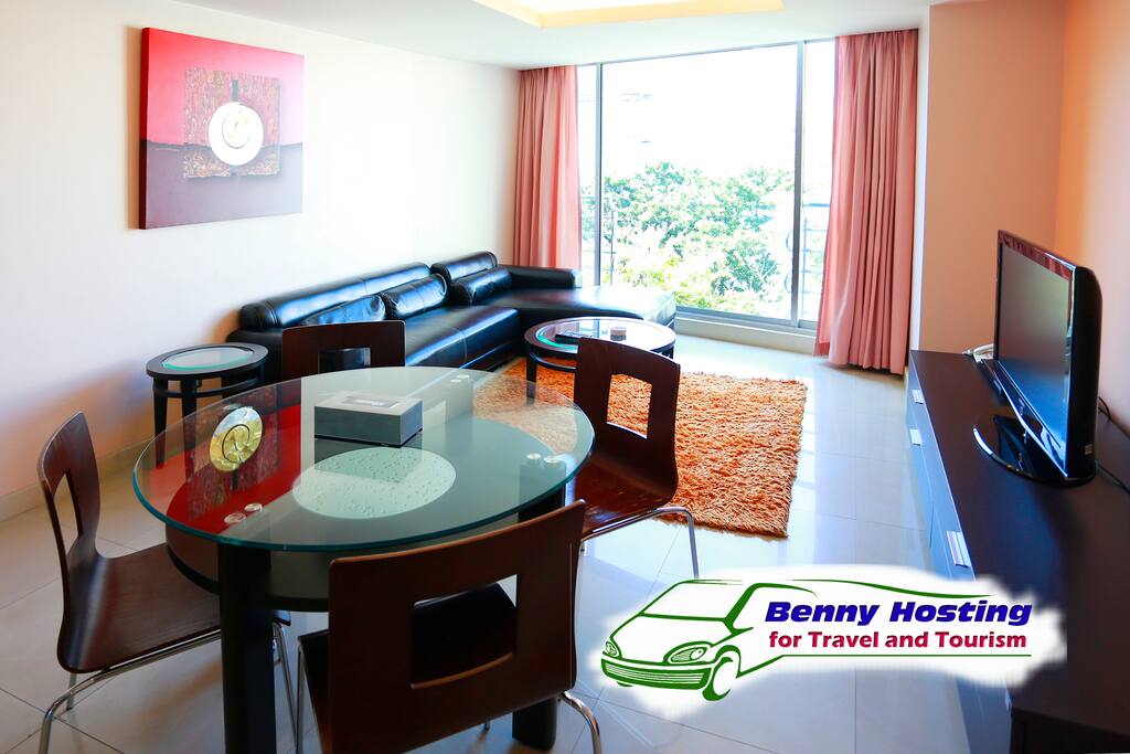 Big living room and dinning room with television.