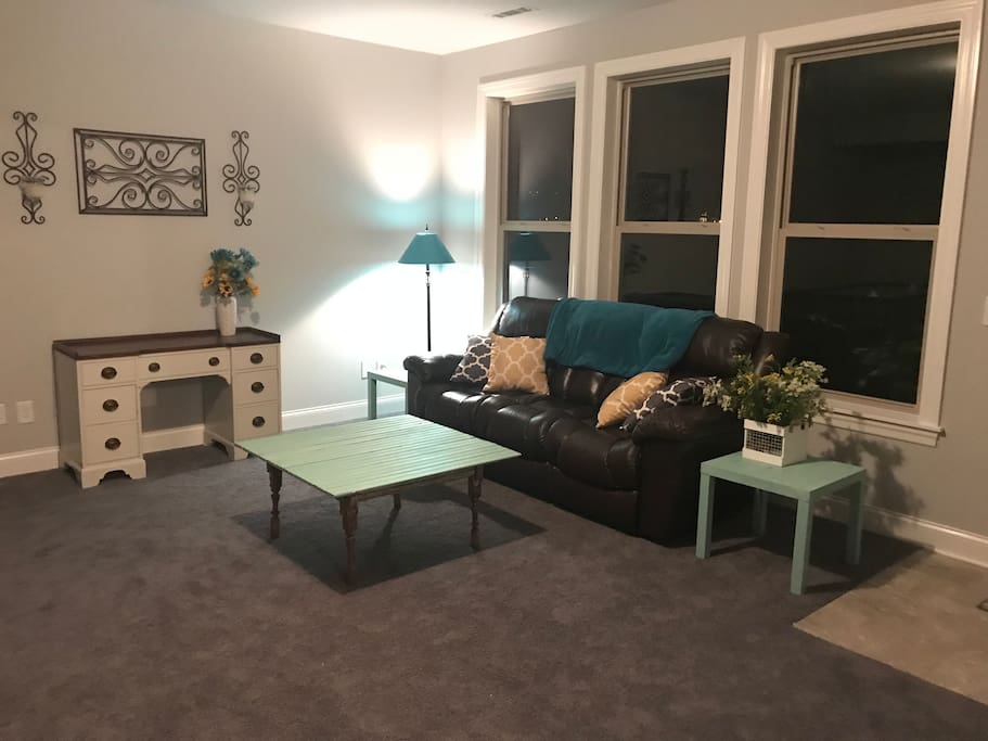 Private home entrance with private living room with couch and desk. Also entrance through the main house.