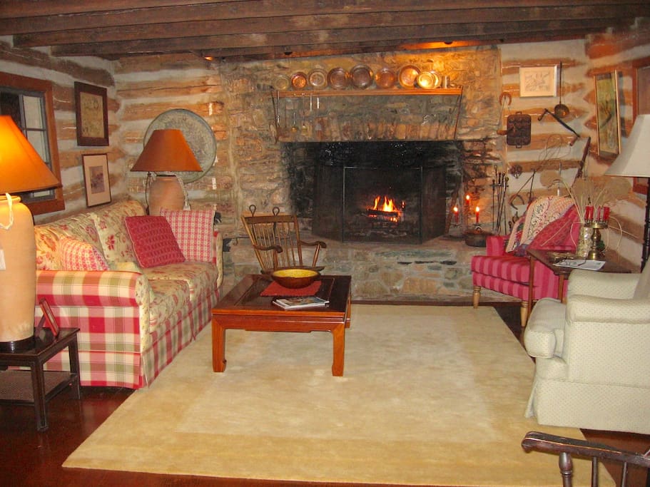 Cozy but spacious log living room, huge original fireplace,lots of wood.