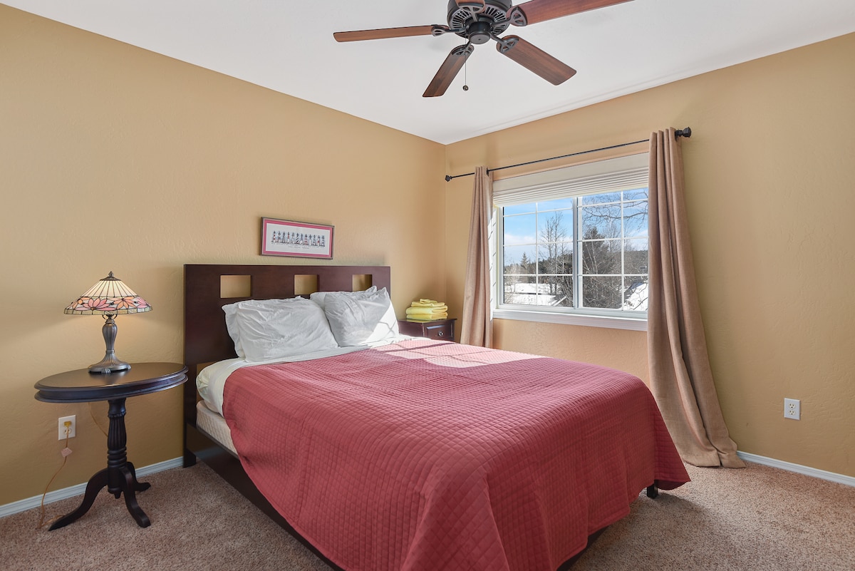 Upstairs bedroom #1 with a queen bed and a closet.