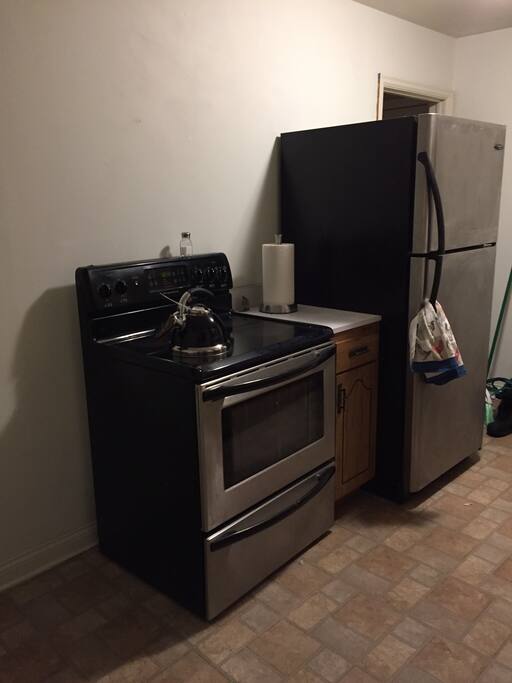 Kitchen with electric stove and refrigerator