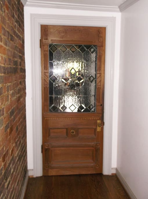 Interior turn-of-the-century entry door with custom leaded glass design.