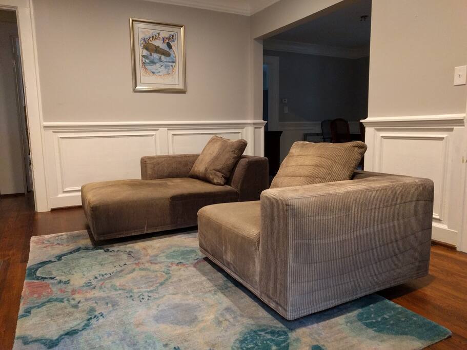 Cozy living room with CB2 gray sectional, soft gray walls, and hand-knotted watercolor rug.