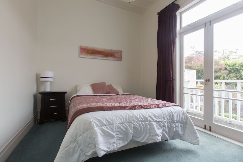 Your room with quality bed and French doors to a small verandah