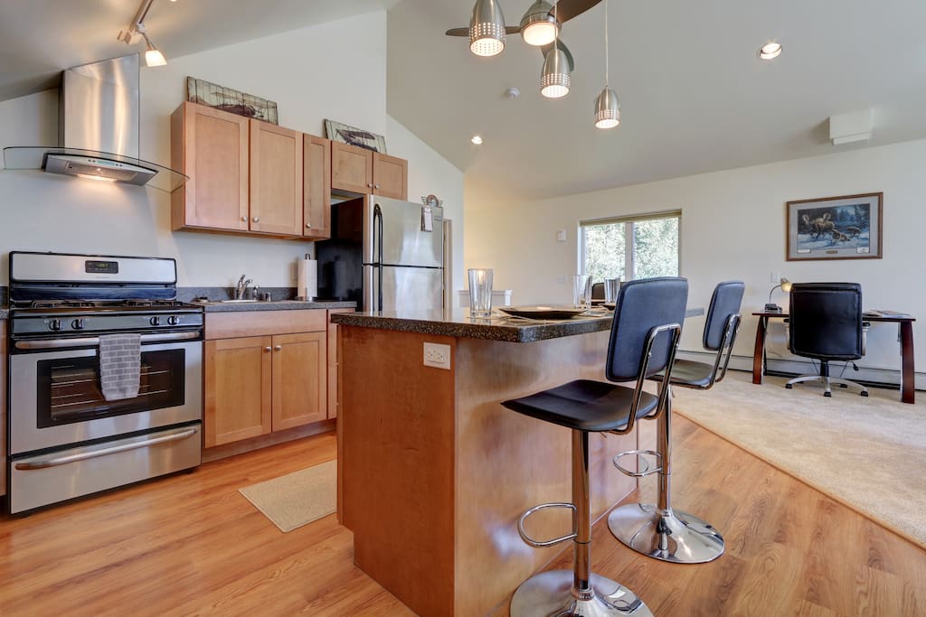 New stainless steal appliances with breakfast bar seating