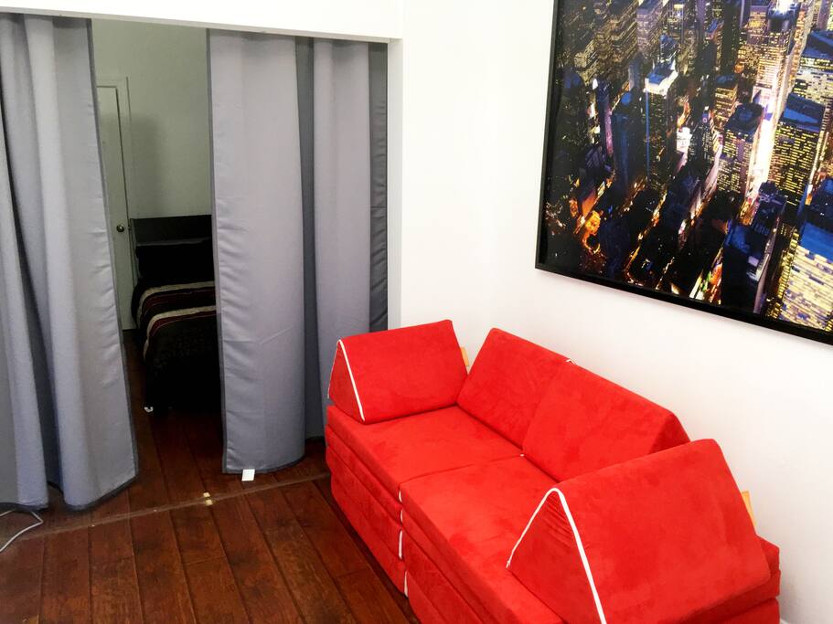 Turn to your right and you'll enter the relatively spacious living room. You'll discover the unique NUGGET SOFA-BEDS that can fit an extra 2 people (for a total of 6 guests). The sofa beds can be changed into tents and playgrounds or more for children.