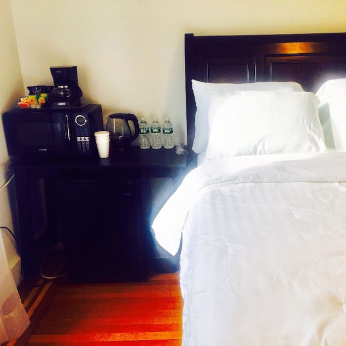 Compact fridge, kettle, microwave , and coffee maker.