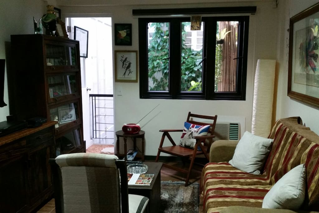 The 2nd floor room has a pull out couch, an entertainment system, 2 hp airconditioning unit, artworks by masters and a small balcony