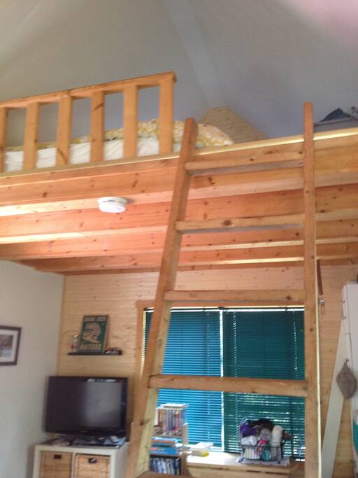 Sleeping loft above with queen size bed