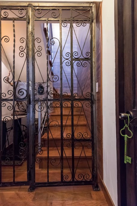The forged iron gate entrance to the duplex, brown door is another housing