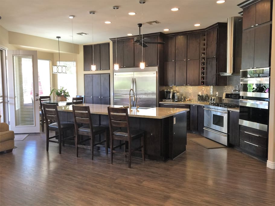 Gourmet kitchen with professional appliances, 3 ovens, huge granite island with seating for 3