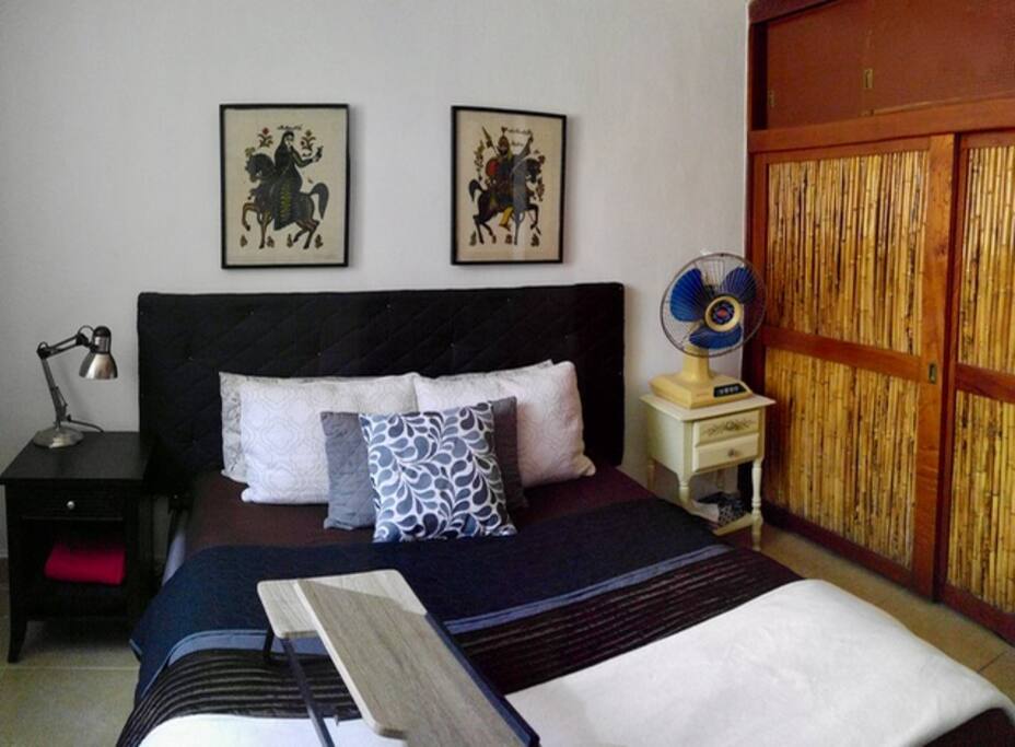 Front bedroom with smart TV (Chromecast), luxury bedding, and a great breeze.