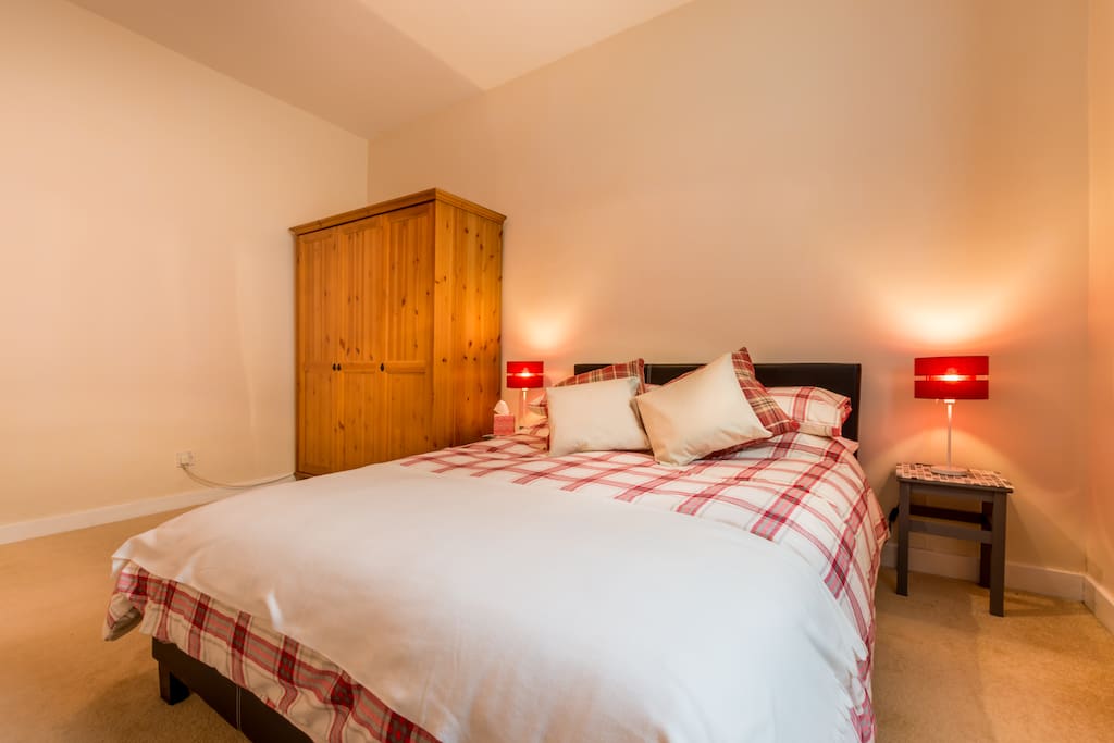 The bedroom has a comfortable double bed and ample storage.