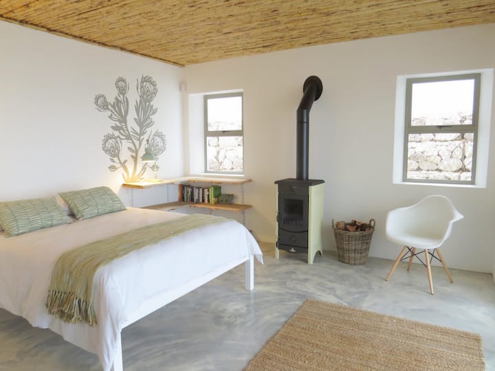 Second of two bedrooms; on the lower level and en-suite. Access to the garden through double glass doors to the right