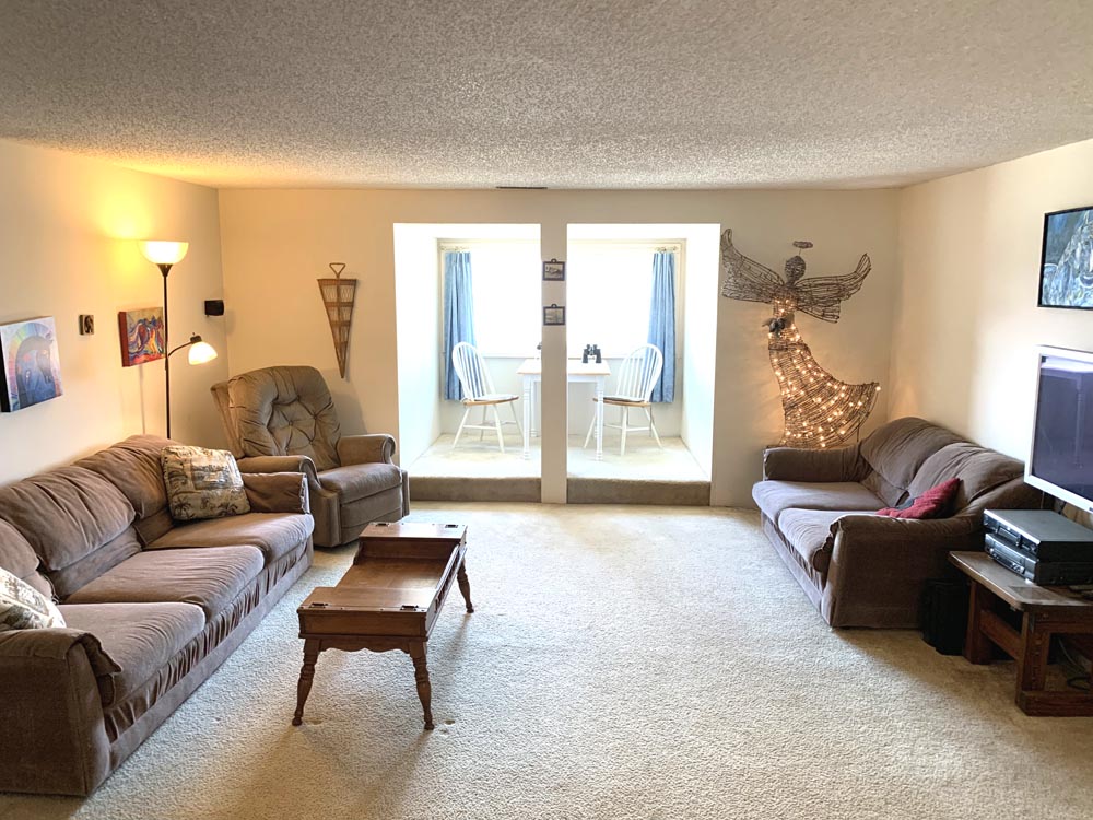 Living Room with a wonderful view of the river, outdoor riding arena and spectacular sunsets.