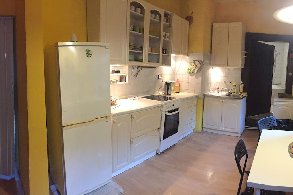 fully furnished kitchen with entrance to bathroom
