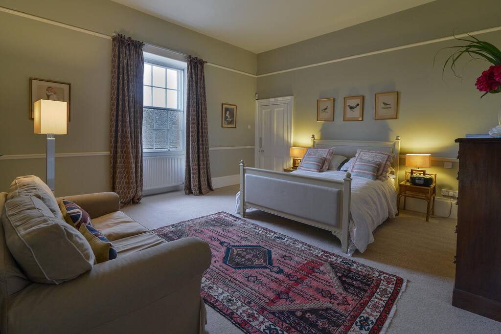 Large and luxurious ensuite bedroom with area to relax