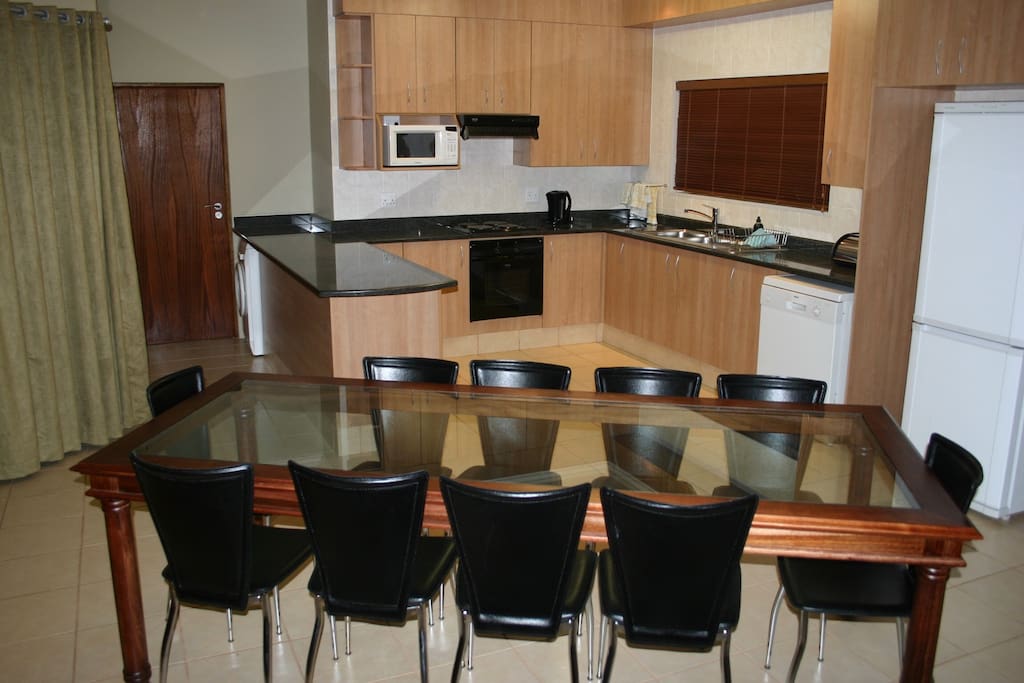 The open plan living area has a lounge with TV, dining area and fully equipped granite top kitchen