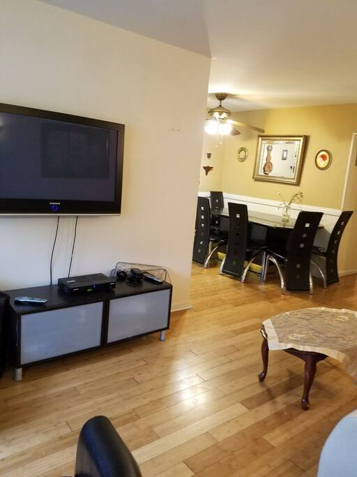 Shared living room + dining room with big screen T.V. for guest use with Netflix!