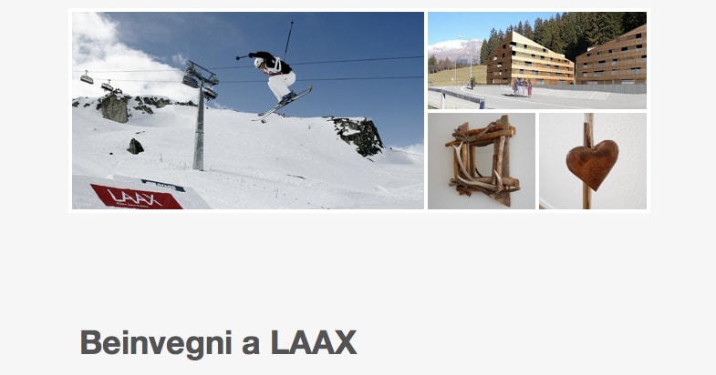 A snowy mountain landscape is showcased with a skier in mid-air, demonstrating a skillful jump. The image conveys the winter sport atmosphere of Laax, surrounded by frosted slopes and a clear blue sky.