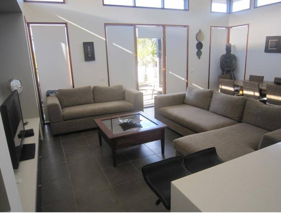 Spacious open plan living area. Couch is fold out sofa bed. TV with DVD and Foxtel
