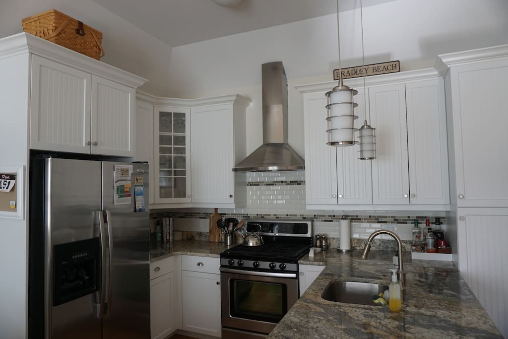 Beautiful open kitchen with stainless steel appliances including dishwasher. Toaster oven, pots & pans included