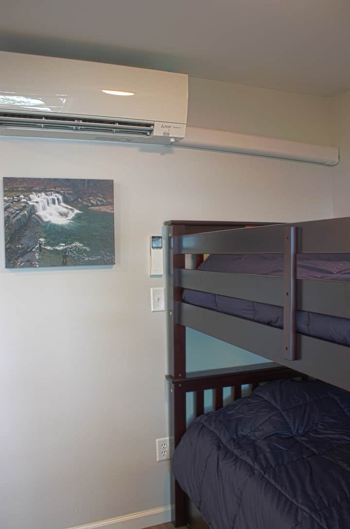 Upstairs bedroom #3 has two single beds and a lake view.  These aren’t rickety just-for-kids bunks, each is solid wood and 400-pound-rated. And both bunks have their own USB outlets - making it easy to charge up, no matter which bed you choose.
