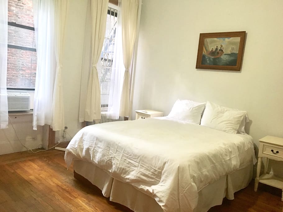 Bedroom with three windows with Winslow's copy on the wall