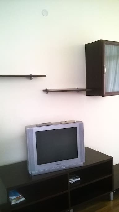 Living room: cable TV set on a TV shelf, where you can place your gadgets, etc.