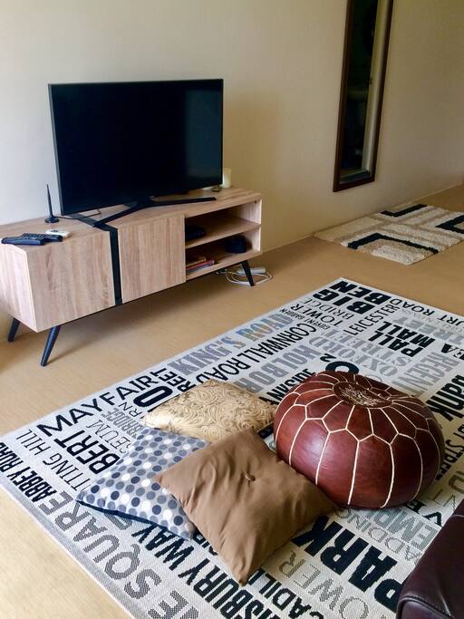 Get cozy on the carpet with this Moroccan poof and throw pillows. Full HD TV is connected to ABS-CBN tv box for your local tv channels.
