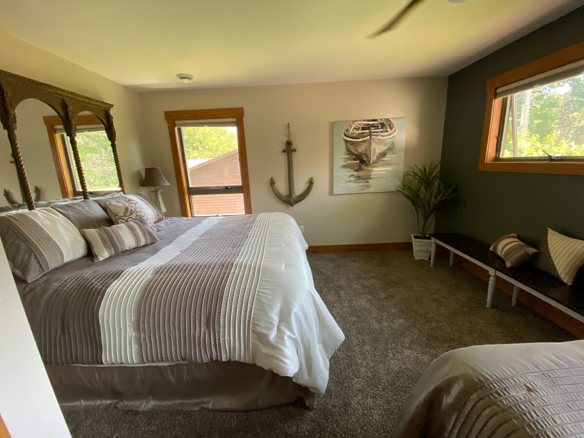 King Bed upstairs with space for luggage.