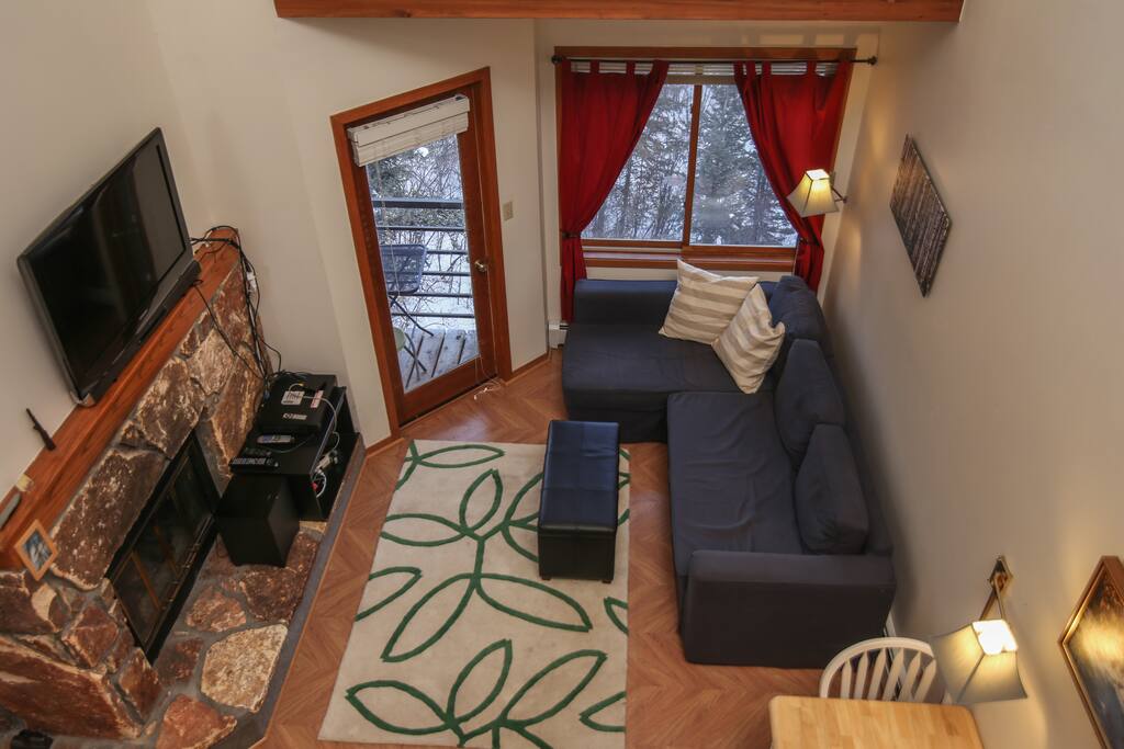 Comfortable living room with pullout sofa. DirectTV and entertainment center also.