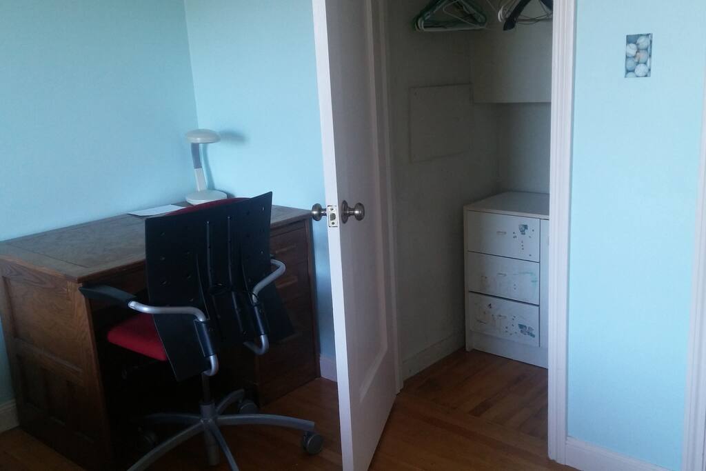 Closet with small dresser.