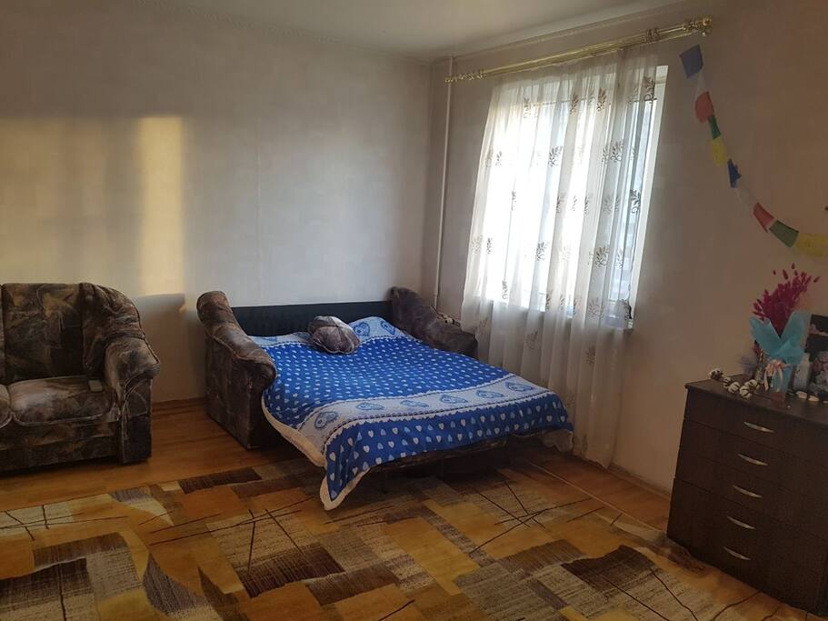 Living room with 2 sofa beds and a work desk
