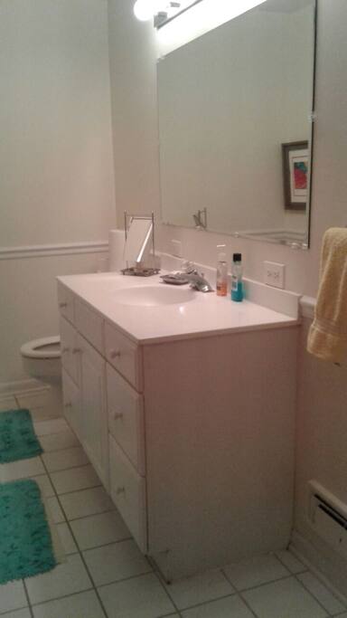 private bathroom with tub/shower across hall from bedroom