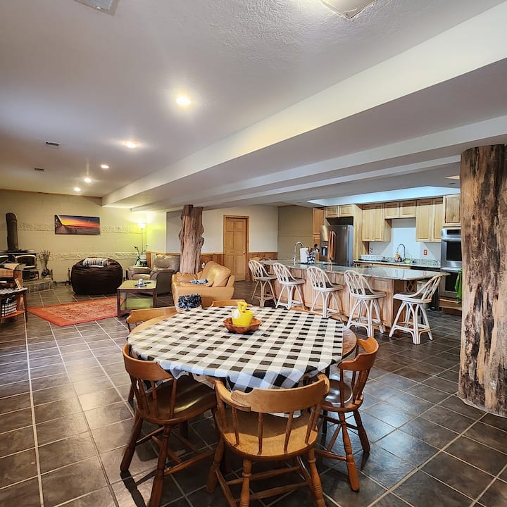 View of the TV/living area, wood-burning fireplace and table. 