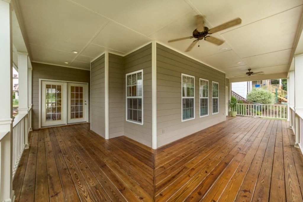 Relax on the porch swing while staying cool under the ceiling fans