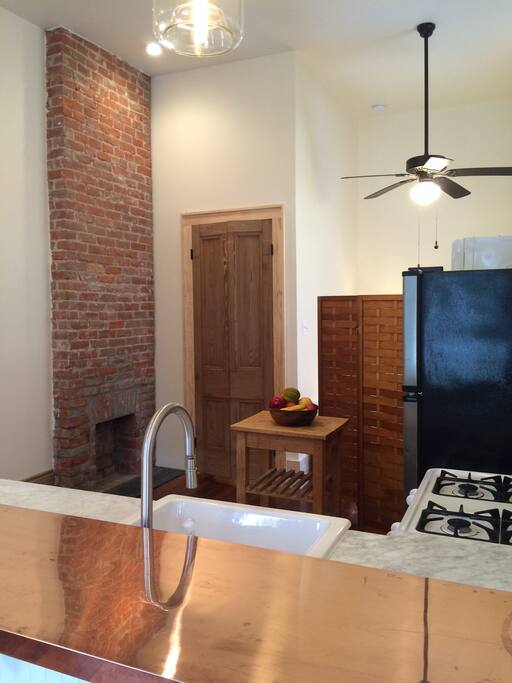 A copper bar and carrara countertop provide elegant accents.