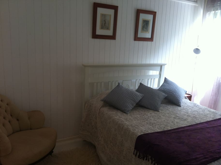 White room. Double bed next to bathroom.