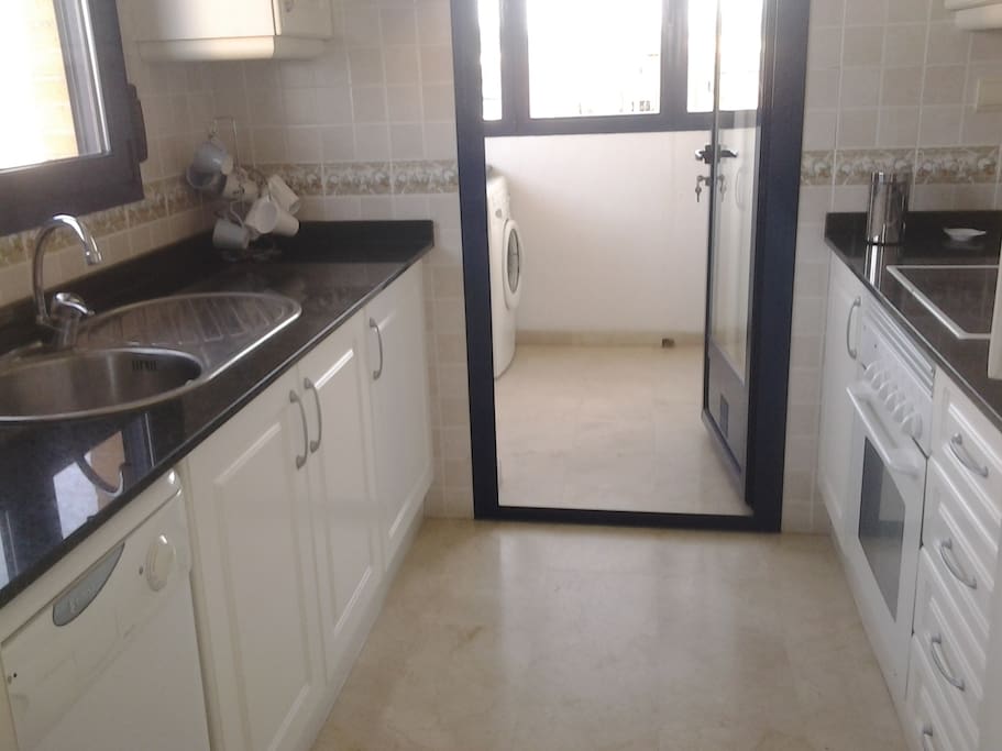 Well equipped kitchen leading to utility
