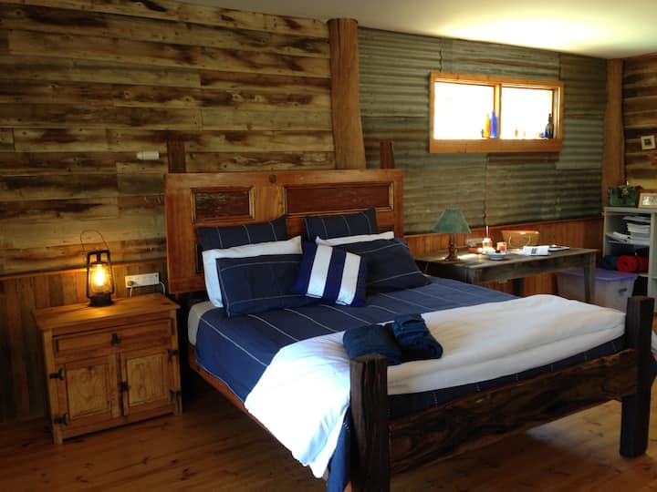 King Size bed built by Justin Corbidge, incorporating re-purposed redgum fence posts and antique timber doors. 2 single Airbeds also available for kids.  