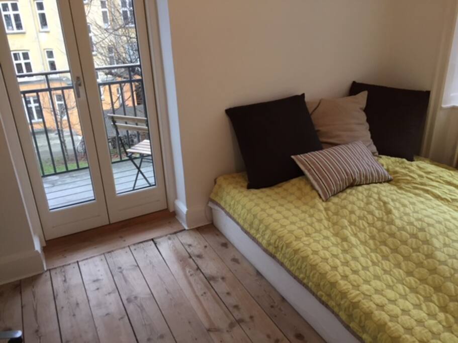 Bedroom with large comfortable double bed and access to balcony