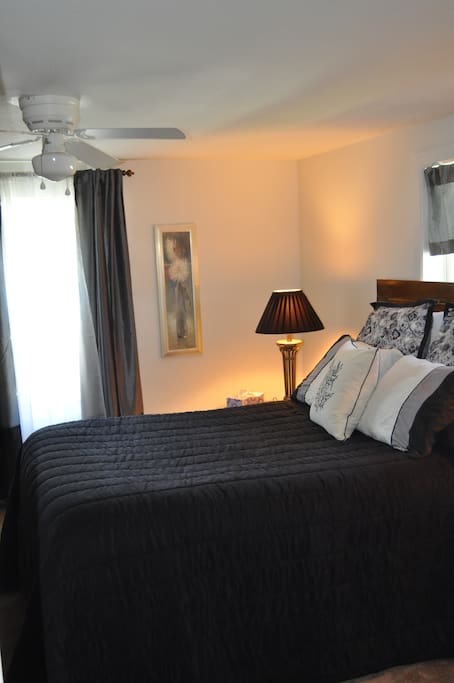 Very comfortable queen sized bed with side tables and a dresser for storage.