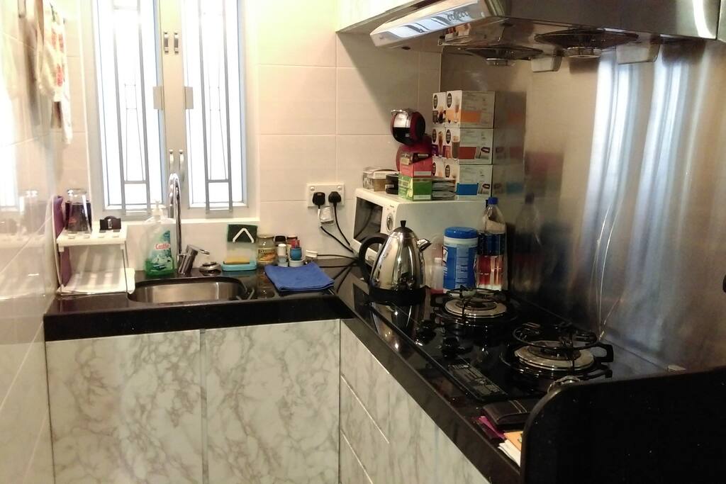 Kitchen with gas stove, microwave and kettle