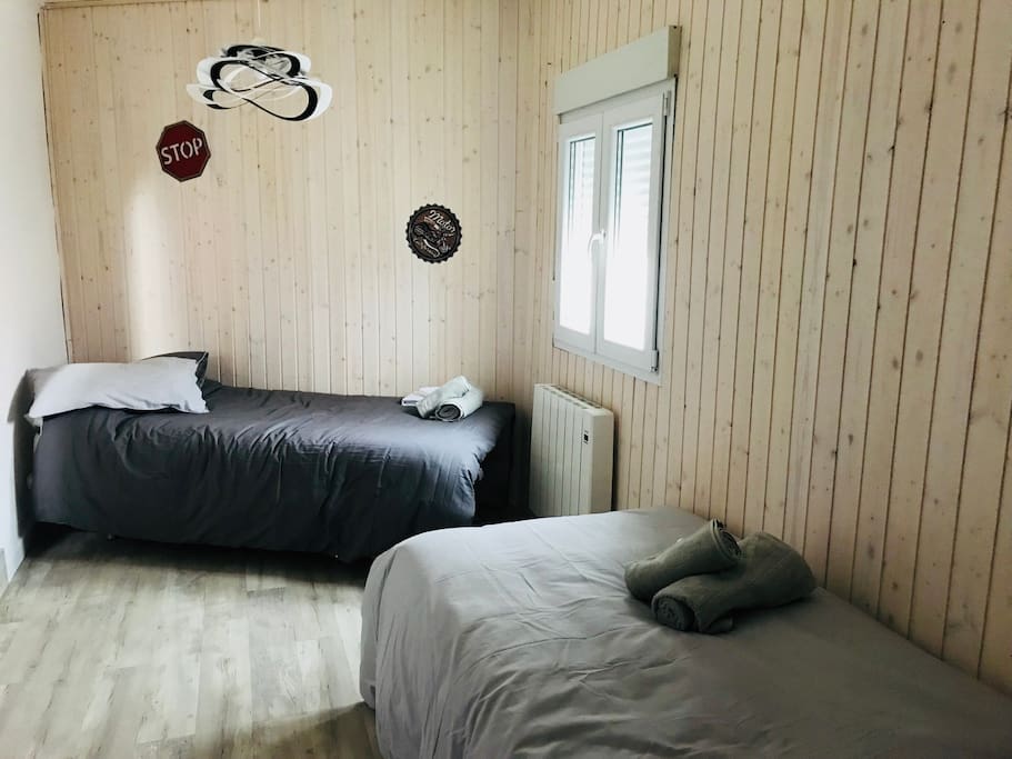 Habitación con 2 camas individuales y un pequeño vestidor.