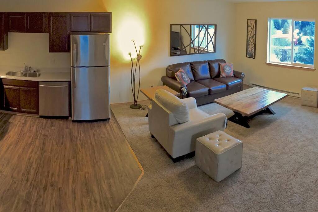Open kitchen and living room space with fireplace.