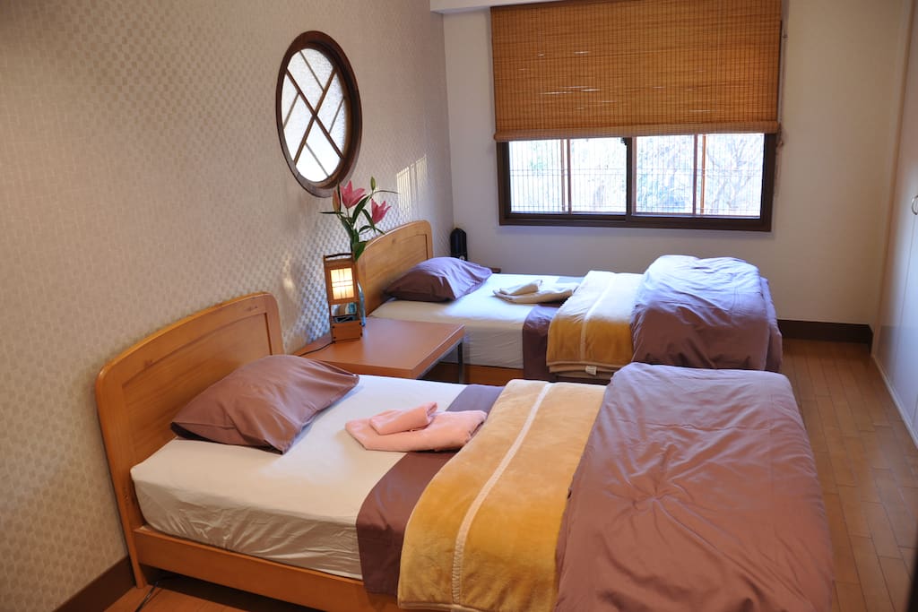 Main bedroom - double windows, comfi mattress, several pillows. Japonesque Western. Large cupboard/storage for suitcases.