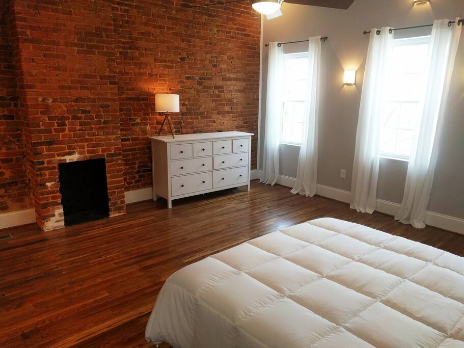 Brick fireplace, vaulted ceilings and lots of natural light in the master suite